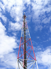 GSM repeater tower in front of blue cloudy sky