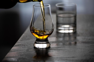 Pouring in tulip-shaped tasting glass Scotch single malt or blended whisky