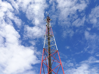 GSM repeater tower in front of blue cloudy sky
