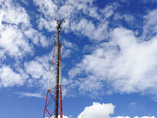 GSM repeater tower in front of blue cloudy sky