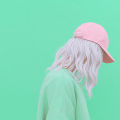 Aesthetic blonde girl in stylish accessories b-boy cap. Fresh vanilla pastel monochrome colours...