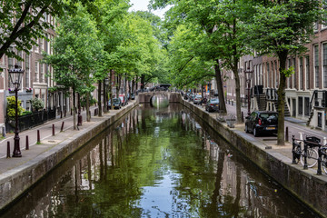 Fototapeta na wymiar Amsterdam, Netherlands - May 2018: Classic Amsterdam canal scene