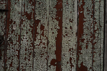 texture of dark old painted wood close up, ragged paint on boards
