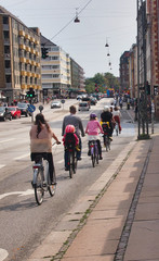 Fototapeta premium People riding bicycles lined up on the road.