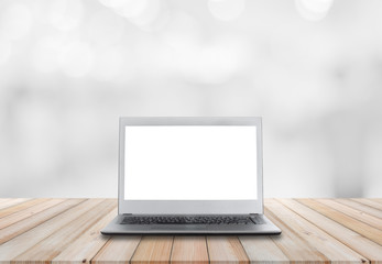 laptop computer blank white screen open front display on wood table with blur room background. technology mockup device black and grey color.