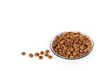 Dry pet food in a white ceramic bowl isolated on white background