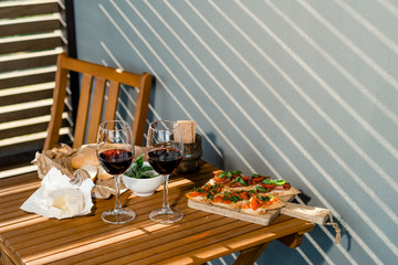 Red wine with charcuterie assortment on the background