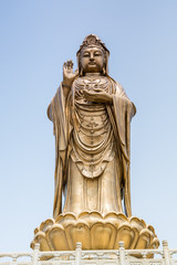 Fototapeta na wymiar Golden statue of bodhisattva guanyin Mount Luojia, which lies in the Lotus Sea to the southeast of Putuo Mountain, Zhoushan, Zhejiang, the place where Bodhisattva Guanyin practiced Buddhism