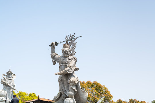 Statue of the Viruḍhaka Heavenly King in front of Golden statue of bodhisattva guanyin Mount Luojia, Zhoushan, Zhejiang, the place where Bodhisattva Guanyin practiced Buddhism