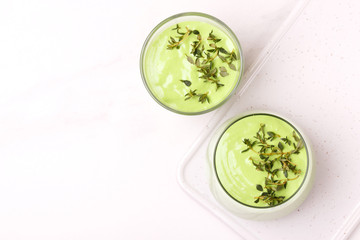 green smoothie with avocado, cucumber, celery and thyme.