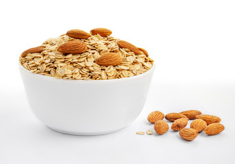 Oatmeal breakfast with almond nuts in bowl isolated on white background. Healthy food concept