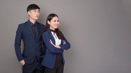 portrait of young Asian confidence business people on gray background