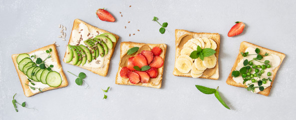 Banner. Bread toast with banana, strawberries, avocado, cucumber, peas. Types of toast for breakfast. Top view.