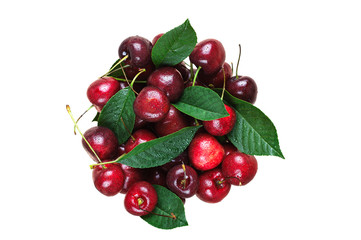 Handful of ripe cherries with leaves on a white background