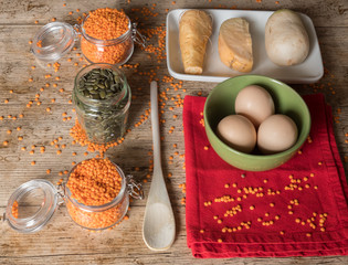 Orange lentils eggs, sunflowers seeds and other vegetables.