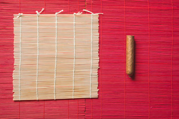New cigar on straw bamboo mat.