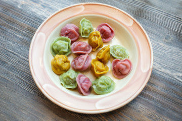 Ready colorful dumplings. Boiled dumplings on a plate. Pelmeni. Pelmeny. Top view, part of kids menu
