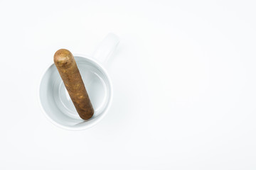 Gorgeous cigar from twisted sheets in mug with white background.