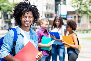 Laughing mexican male student with group of multi ethnic young adults