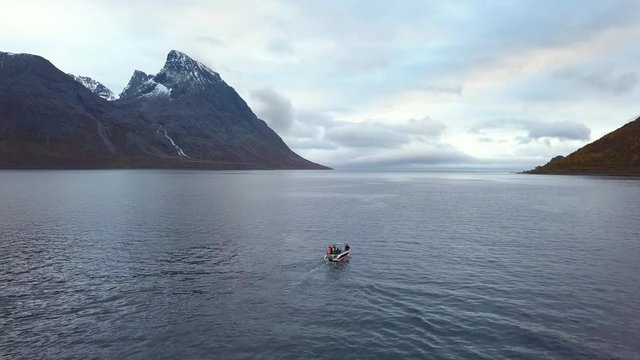 A small fishing boat driving in the sea in Norway