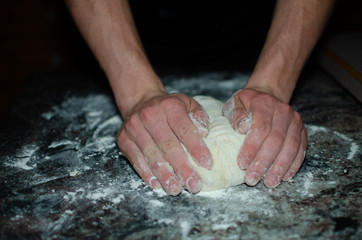 hands kneading dough