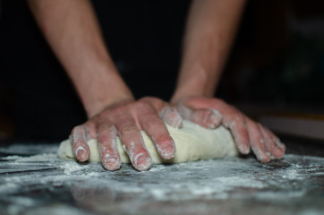 hands kneading dough