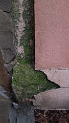 old stone wallю Closeup of old rough pink wall surface of ruined building