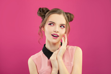 Young model woman on bright pink background