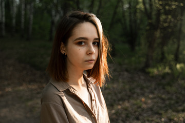 Fototapeta premium portrait of a girl with brown hair in the forest