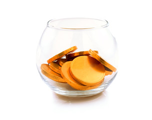 Gold coins in glass bowl