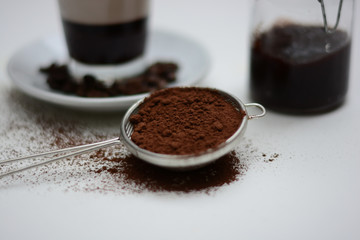 Cocoa powder arranged with coffee and plum jam