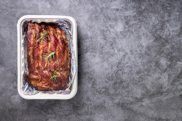 Grilled pork ribs with Vegetables and sauces on a drak table