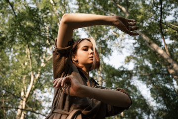 girl closes her hands from the sun