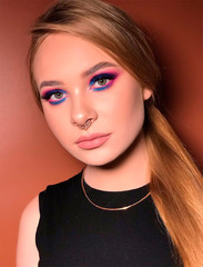 Fototapeta premium Portrait of a beautiful girl. Natural fair hair. Bright blue makeup. Puffy lips. Northern appearance.