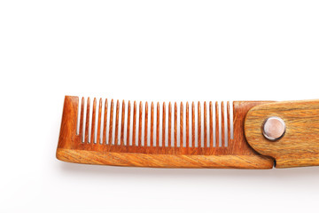 Wooden comb made of natural sandalwood for men on a white background.