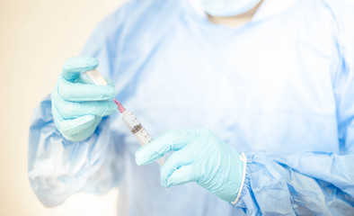 Syringe medical injection in hand holding with medicine dose vaccination equipment with needle. vaccination to patient for coronavirus (COVID-19) protection.