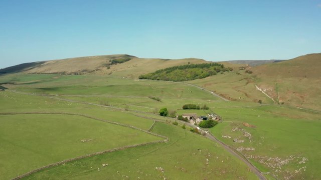 Aerial view of a road and farmhouse in the Peak District, Derbyshire UK