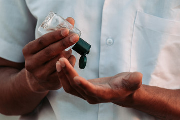 Closeup shot of hand of an Indian man using Hand sanitizer during the corona virus pandemic