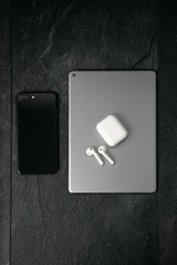 Top view of a Tablet and Smartphone on stone background with headphones