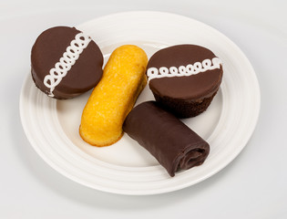 Cupcake along with an assortment of other snacks on a plate