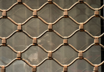 Naklejka premium decorative elements of wrought iron grilles in the window