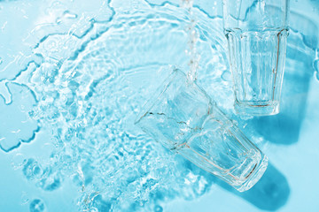 Water glass transparent underwater top view on blue background