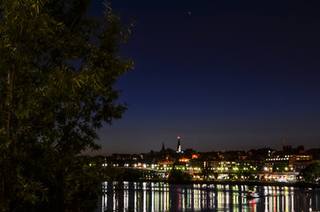 Potomac river with skyline of Georgetown at night with light reflection