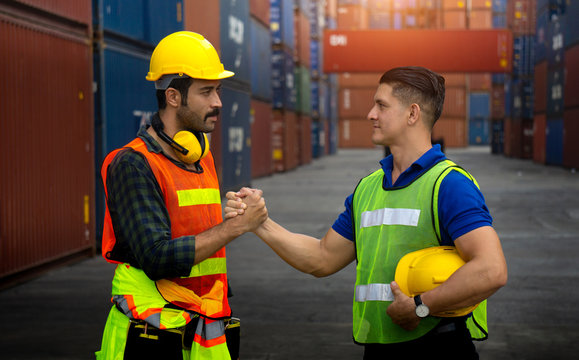 Two cargo workers join hands