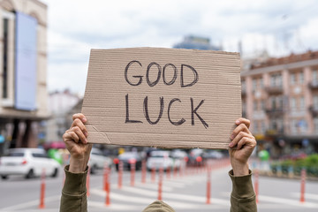 Happy kind wish. Good luck. Hand holding sign outside on street. Social public messages on banners...