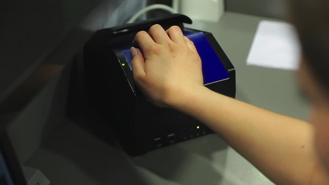 border officer scans passenger's passport. database search during id scan