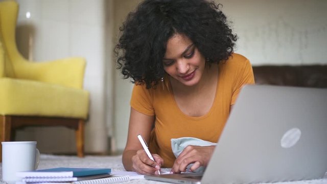 girl university college student online video lesson with teacher tutor Spbd. distant remote learning on lockdown quarantine. multi racial young woman talking and smiling