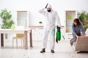 Young male contractor and female client during pest control