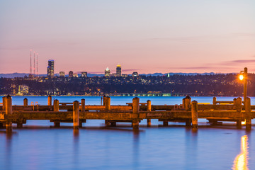  dock with background of Bellevue cityscape with reflection on lake washington at night