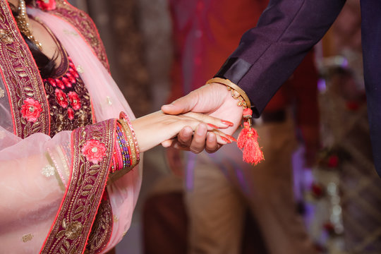 Close up of Indian couple's hands at a wedding